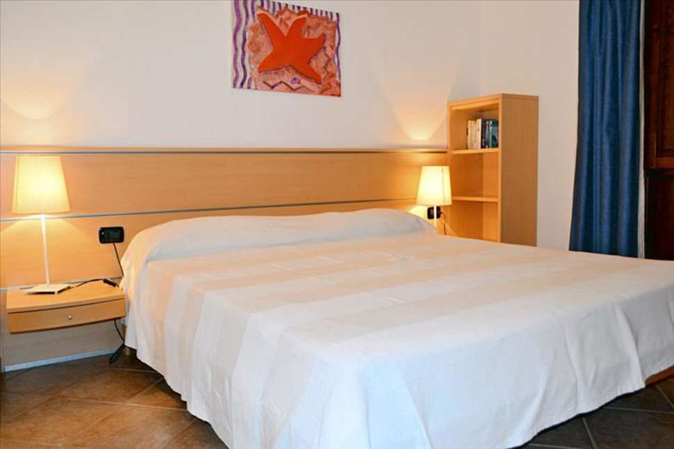 Slaapkamer van Villagio Porto Corallo in Porto Corallo, Sardinië